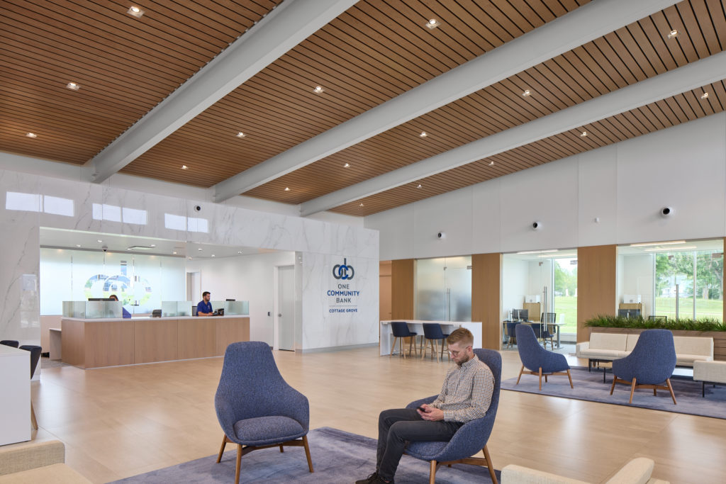 Man sits in modern blue chair in lobby area